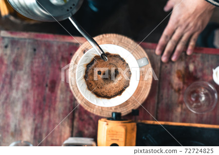 Drip coffee, barista pouring water on coffee ground with filter 72724825