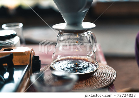 Drip coffee, barista pouring water on coffee ground with filter 72724828