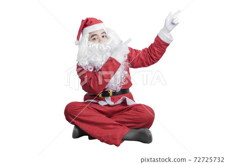 Asian man in Santa costume pointing something Asian man in Santa costume pointing something 72725732