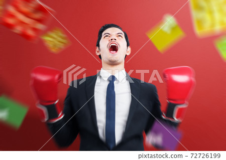 Asian businessman with boxing gloves celebrate boxing day sale 72726199