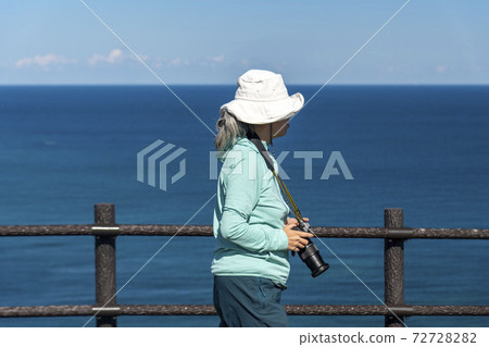 Female photographer shooting at Rebun Island Todojima Observatory Female photographer shooting at Rebun Island Todojima Observatory 72728282