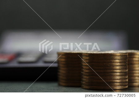 Stacked 500 yen coins and calculator Stacked 500 yen coins and calculator 72730005