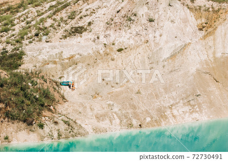 Vaukavysk chalk pits or Belarusian Maldives are beautiful saturated blue lakes.Two tourists pull a boat out of the water Belarus. 72730491