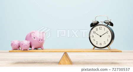 Seesaw piggy bank and clock business concept Seesaw piggy bank and clock business concept 72730537