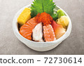 Bowl of rice topped with sashimi  72730614