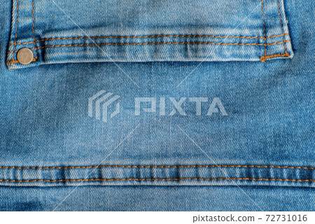 Jeans back pocket close up. Denim blue. Stitching on jeans. Rivets Jeans back pocket close up. Denim blue. Stitching on jeans. Rivets 72731016