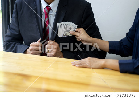 Businessman send cash money to the officer to sign in the contact Businessman send cash money to the officer to sign in the contact 72731373