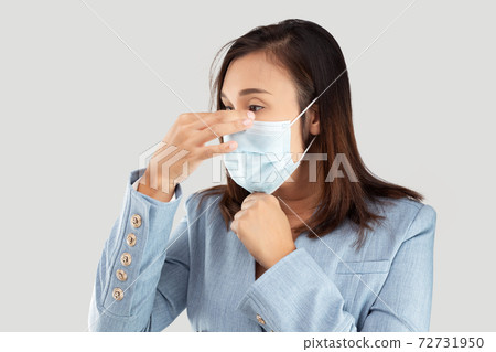 Woman wearing a medical mask Woman wearing a medical mask 72731950