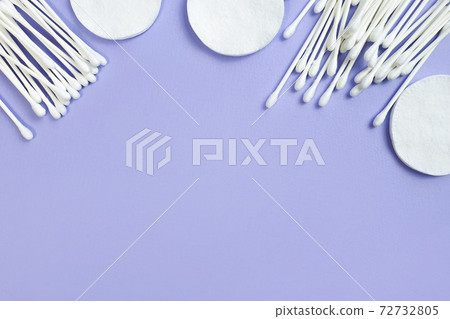 Cotton pads and sticks on light purple background. Top view, free space for product or text. Flat lay style Cotton pads and sticks on light purple background. Top view, free space for product or text. Flat lay style 72732805