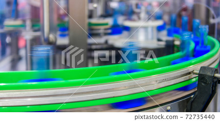 Clear blue glass bottles transfer on Automated conveyor systems industrial automation for package 72735440