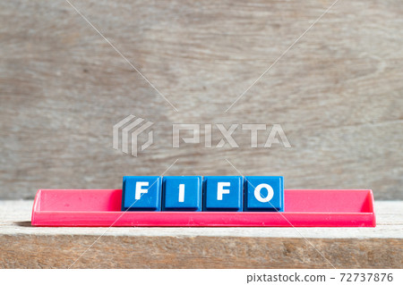 Tile letter on red rack in word FIFO (Abbreviation of first in first out) on wood background 72737876