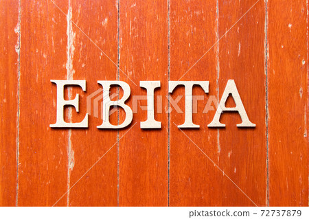 Alphabet letter in word EBITA (abbreviation of  earnings before interest, taxes and amortization) on old red color wood plate background 72737879