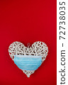 White heart with a blue face mask on a red background. Concept of a Valentines day during Coronavirus or Covid pandemic. 72738035
