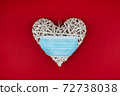 White heart with a blue face mask on a red background. Concept of a Valentines day during Coronavirus or Covid pandemic. 72738038