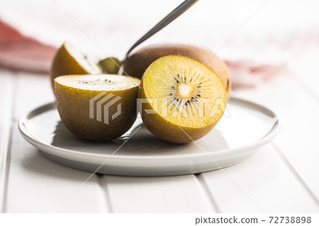 Halved ripe yellow kiwi fruit. Halved ripe yellow kiwi fruit. 72738898