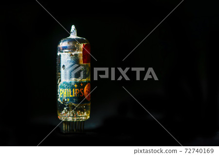 Old PHILIPS valve on black background 72740169
