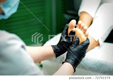 Beautician doing massage on the sole Beautician doing massage on the sole 72741574