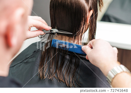 Hairdresser cutting hair of woman. Hairdresser cutting hair of woman. 72741648