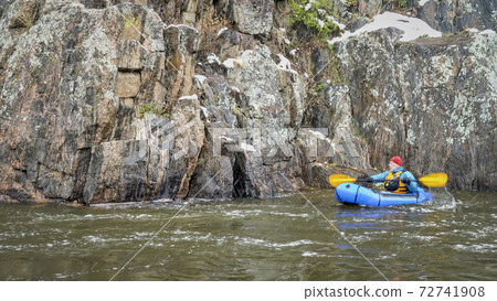 packraft  paddling in snowstorm 72741908