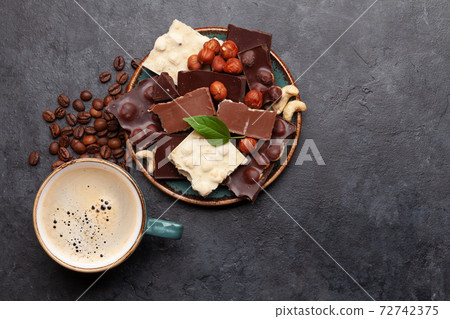 Various chocolate pieces, coffee and nuts 72742375