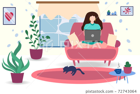 A woman works on a laptop at home on the couch. Freelance concept, quarantine due to covid-19 72743064