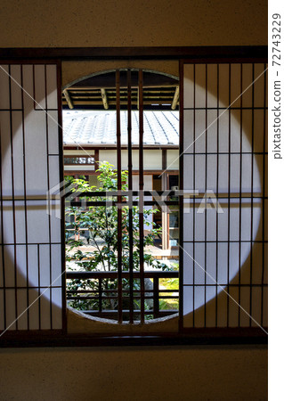 The courtyard seen from the circular window of a Japanese house The courtyard seen from the circular window of a Japanese house 72743229