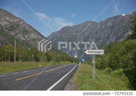 Road sign showing directions to famous tourist destination Troll Wall in Trollveggen in Norway Road sign showing directions to famous tourist destination Troll Wall in Trollveggen in Norway 72743310