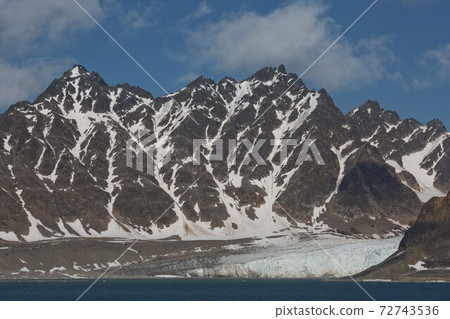 The coastline and mountains of Liefdefjord in the Svalbard Islands (Spitzbergen) in the high Arctic 72743536
