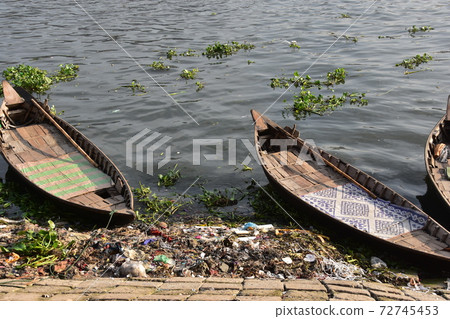 Many ferryboats parked in Dhaka Shodolgat, Bangladesh, an old small boat made of wood Many ferryboats parked in Dhaka Shodolgat, Bangladesh, an old small boat made of wood 72745453