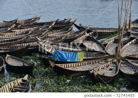 Many ferryboats parked in Dhaka, Bangladesh, people who sleep with mosquito nets on board 72745485