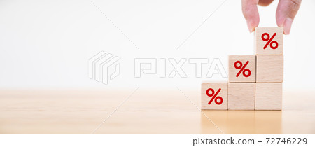 Hand putting wood cube block increasing on top with icon percentage symbol upward direction Hand putting wood cube block increasing on top with icon percentage symbol upward direction 72746229