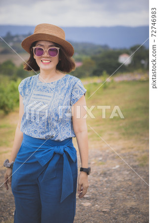 asian woman standing outdoor with toothy smiling asian woman standing outdoor with toothy smiling 72746983