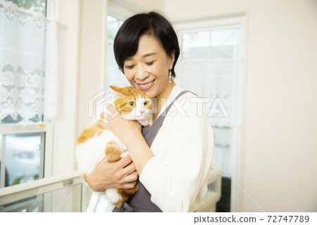 A woman holding a cat A woman holding a cat 72747789