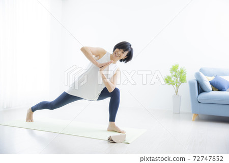 A woman in her 50s doing yoga A woman in her 50s doing yoga 72747852