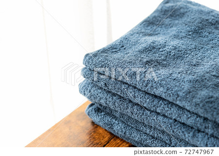 Blue face towel on the walnut table Blue face towel on the walnut table 72747967