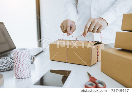 Young asian teenage product owners are packing small business packaging products in boxes prepared for shipping. Young asian teenage product owners are packing small business packaging products in boxes prepared for shipping. 72749427