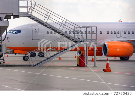 Making landing at the airport, plane and airport, the plane on the runway. Making landing at the airport, plane and airport, the plane on the runway. 72750423