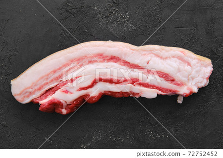 Raw fresh pork belly slice on black background 72752452