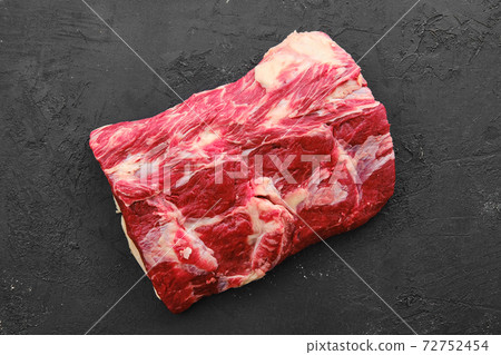 Raw fresh beef chuck center roast on black background 72752454