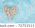 White heart on a background of a blue faces masks. Concept of a Valentines day during Coronavirus or Covid pandemic. 72753513