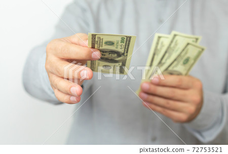 Hands of man proposing money us dollar bills to you Hands of man proposing money us dollar bills to you 72753521