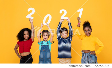 Smiling mixed race children holding 2021 numbers isolated for new year  concepts 72753996