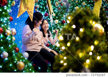 Happy asian family,beautiful mother and child girl are sitting at the Xmas tree,celebrating Christmas,loving mother and daughter enjoying,fun,festive Christmas,new year decoration,celebration concept Happy asian family,beautiful mother and child girl are sitting at the Xmas tree,celebrating Christmas,loving mother and daughter enjoying,fun,festive Christmas,new year decoration,celebration concept 72758167