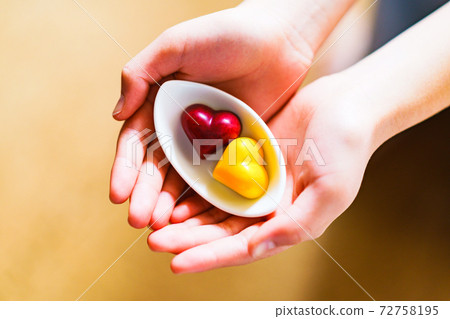 Valentine chocolate pair female hands [Valentine image] 72758195