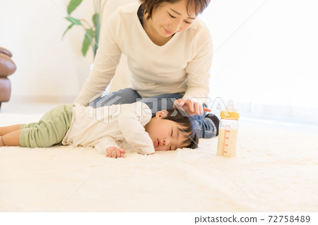 A baby who has been sleeping while breastfeeding A baby who has been sleeping while breastfeeding 72758489