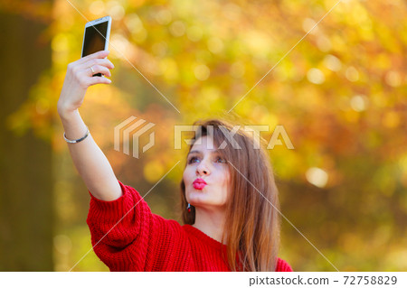 Lovely girl with smartphone taking selfie photo. Lovely girl with smartphone taking selfie photo. 72758829