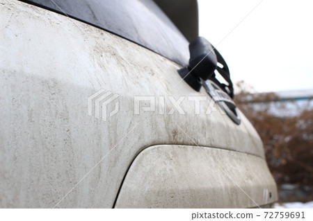 Muddy car body after a snowy or rainy day 72759691
