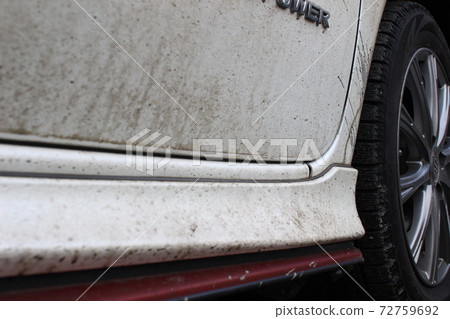 Muddy car body after a snowy or rainy day 72759692
