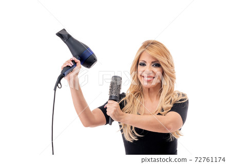 Woman hairdresser with dryer and comb posing for beauty salon advertisement. Portrait on white isolated background. 72761174