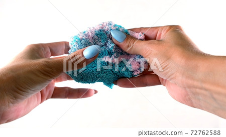 Female hands are molded from light airy multicolored blue plasticine, developing activities for Female hands are molded from light airy multicolored blue plasticine, developing activities for 72762588